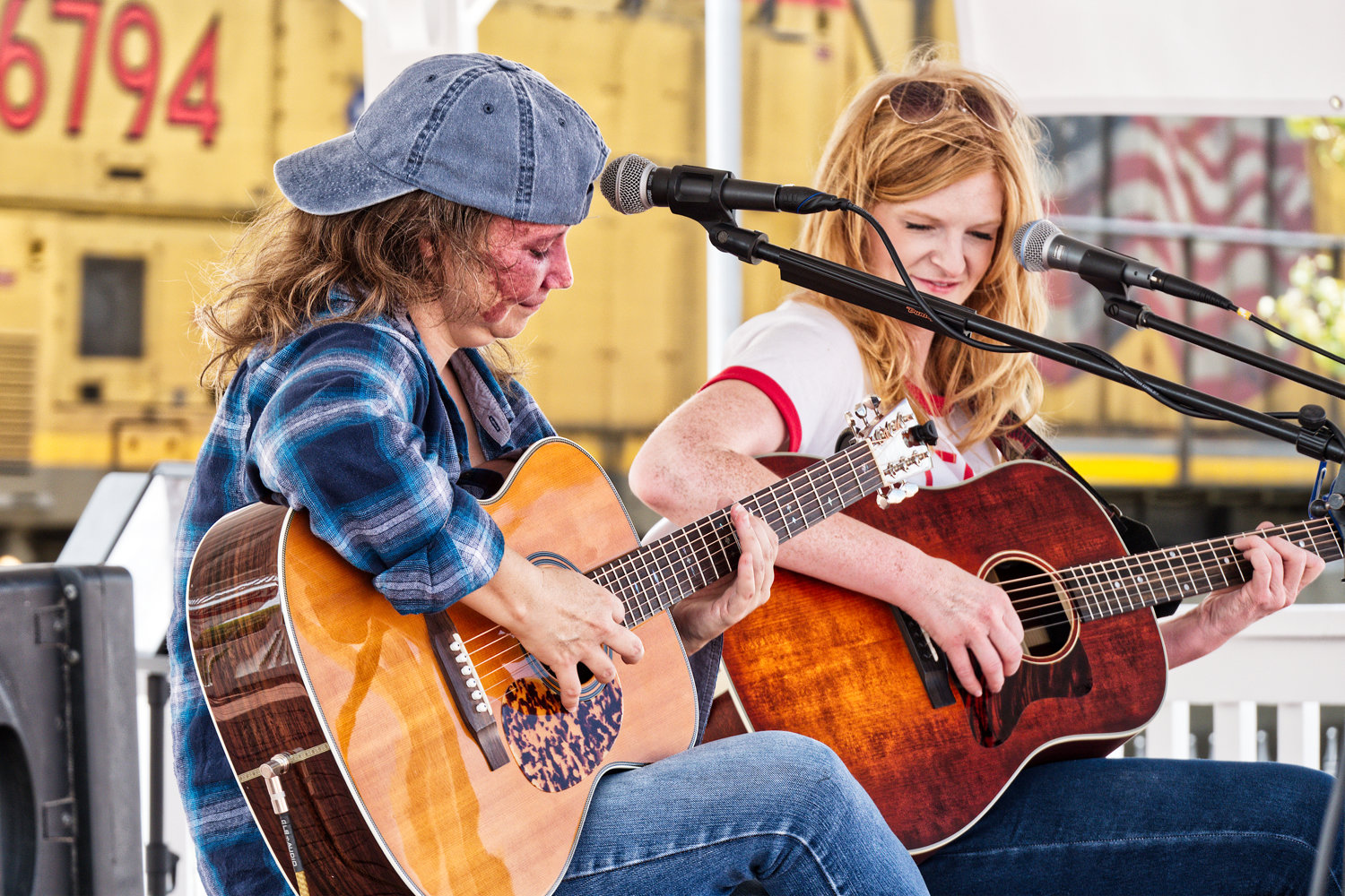 Heather Little and Meredith Crawford play as the Union Pacific train roars through the downtown area.